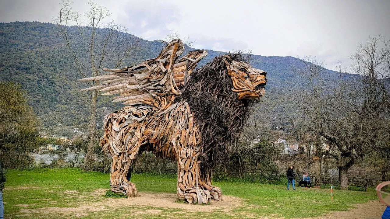 Wood sculpture of a winged lion in the countryside